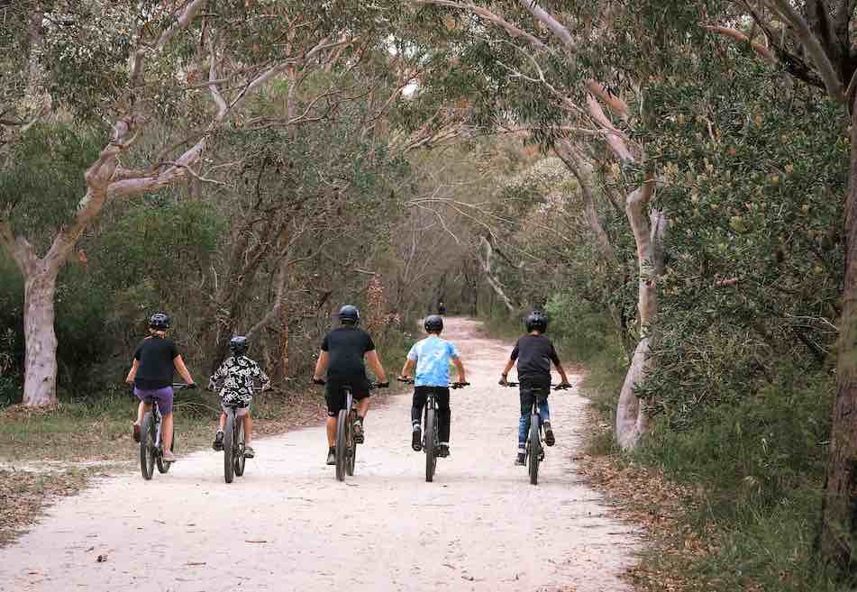 Happy financially secure family playing on the beach at the day time